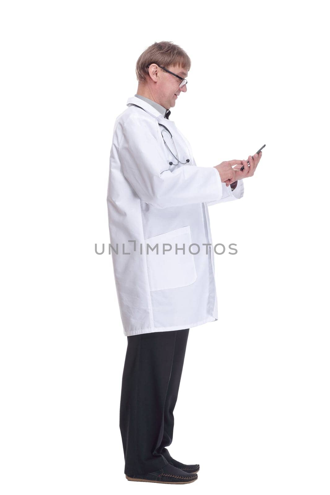 smiling doctor with a smartphone looking at you . by asdf