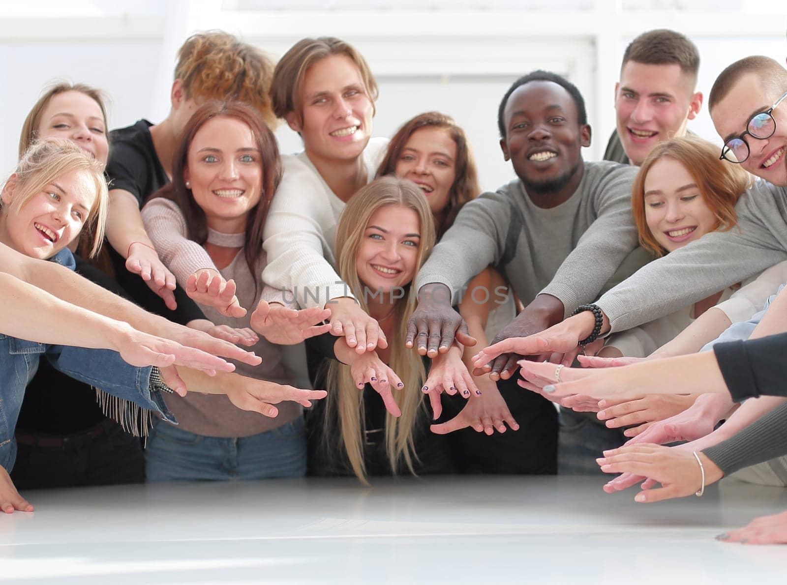 multinational group of young people joining their palms. photo with copy space