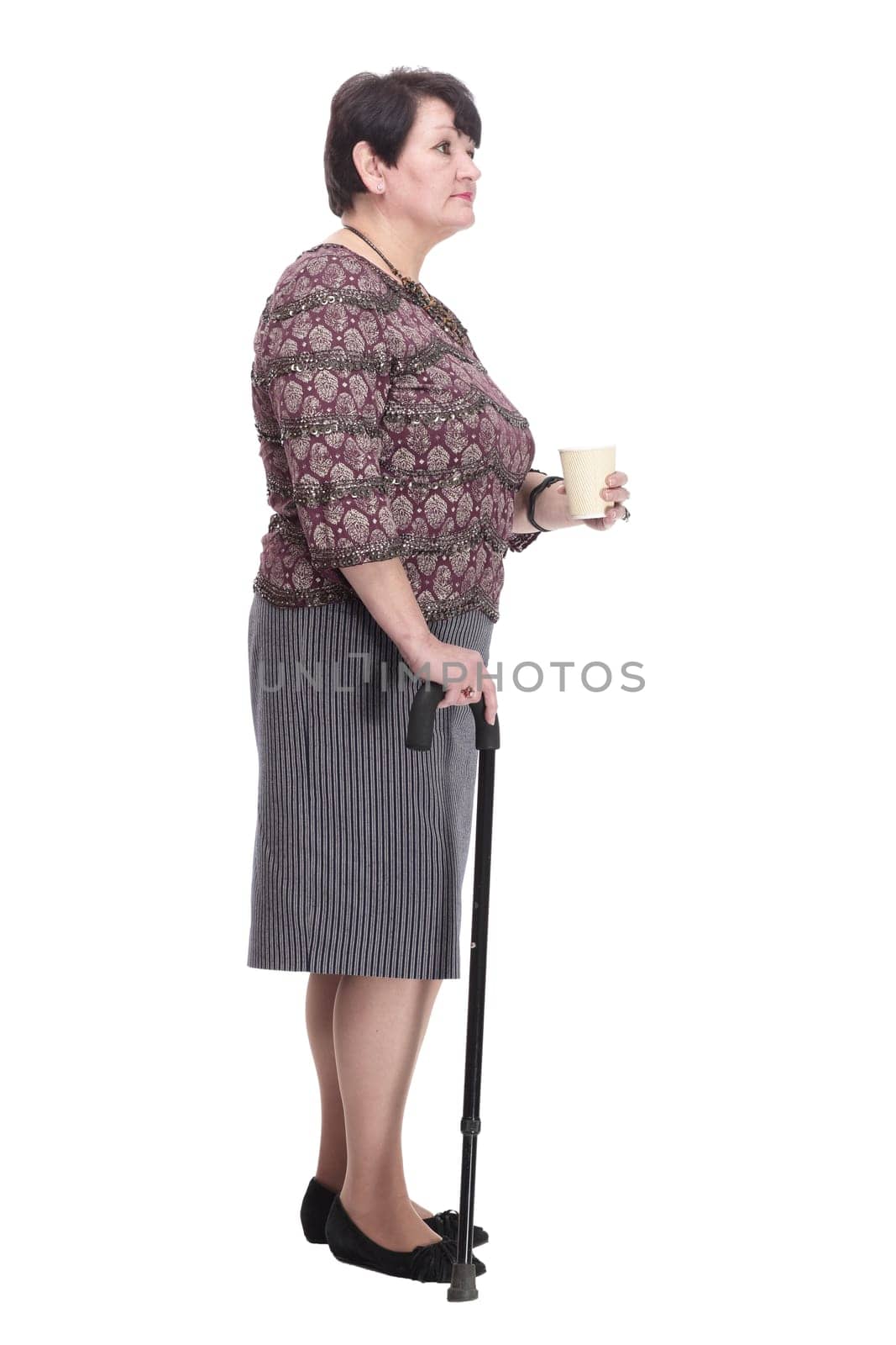 full-length. casual elderly woman with takeaway coffee. isolated on a white background.