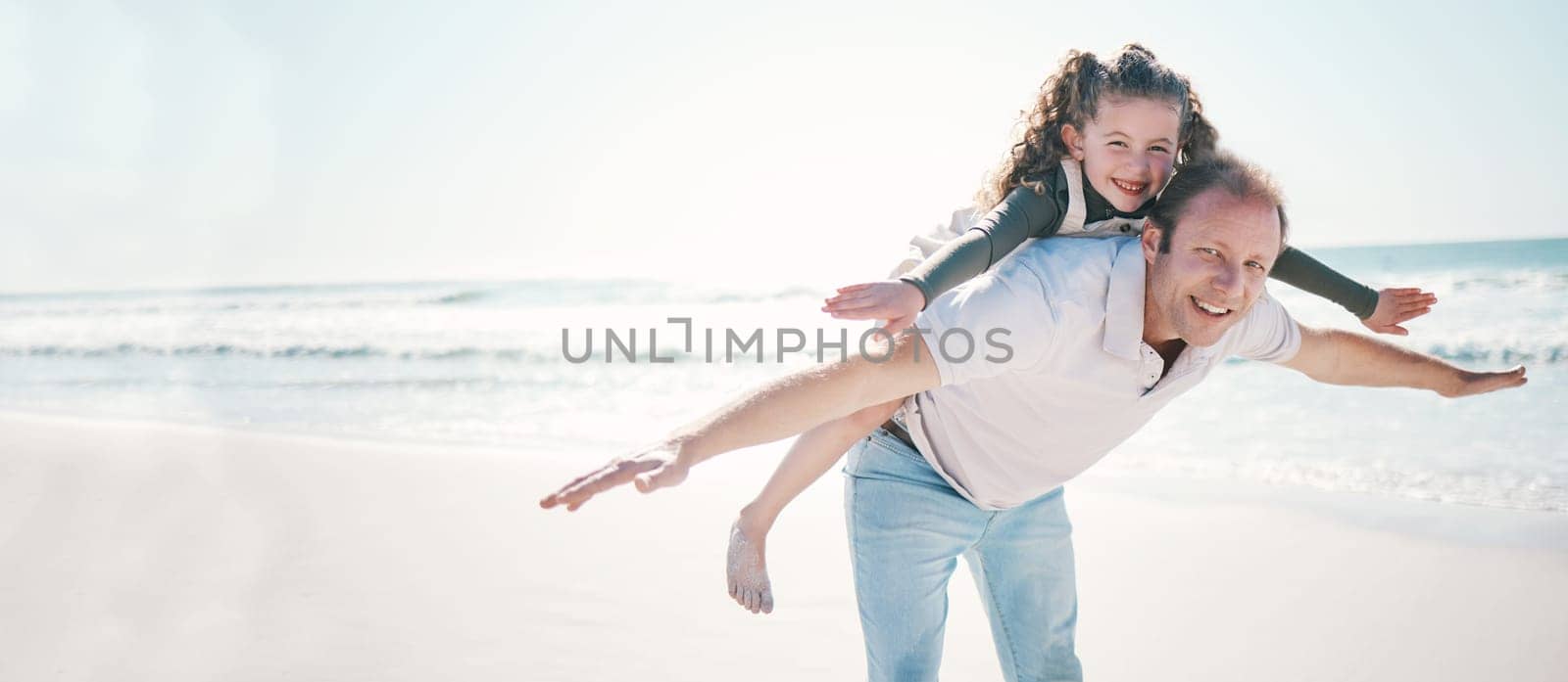 Beach, flying and father with girl, portrait and summer vacation with love. smile and bonding. Happy family, parent and dad carrying child, kid and freedom with travel, seaside holiday and energy.