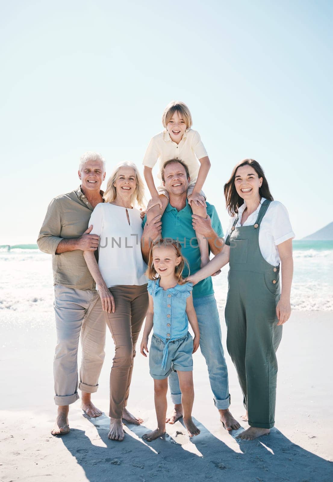 Big family, grandparents portrait or happy kids at sea to relax or travel on beach holiday together. Dad, mom or children siblings love bonding with senior grandmother or grandfather in Australia.