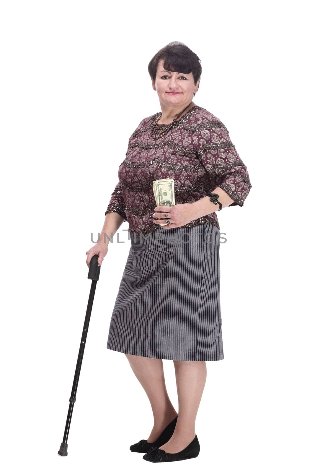 full-length. casual elderly woman with a fan of banknotes. isolated on a white background.