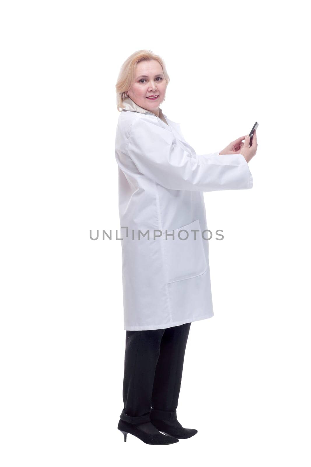 Concentrated beautiful female doctor reading text message by asdf