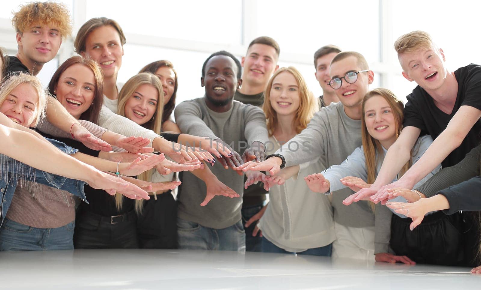 multinational group of young people joining their palms. photo with copy space