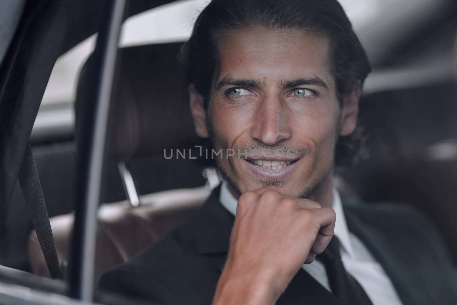 closeup.successful businessman sitting in a prestigious car