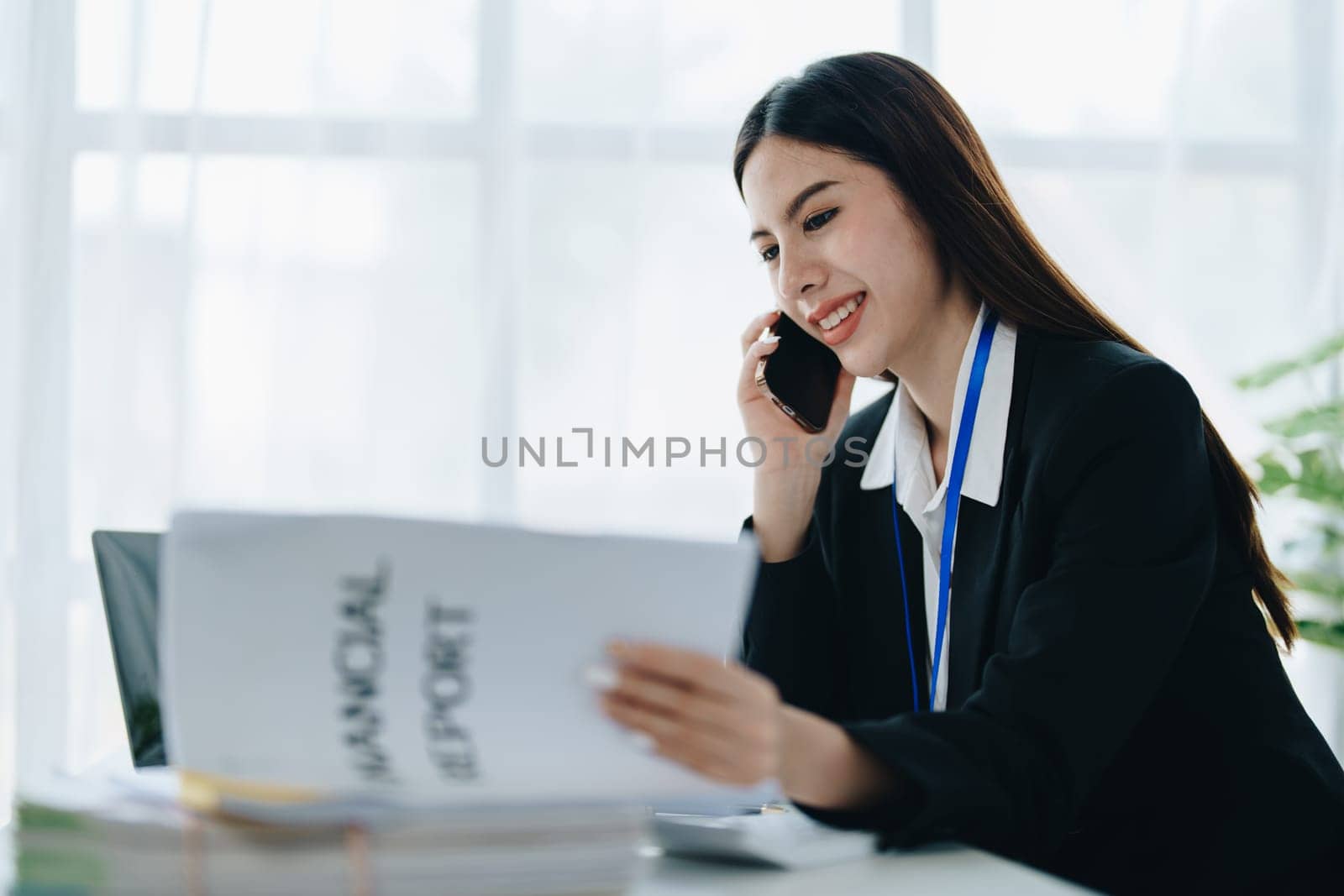 Beautiful young teen asian businesswoman using laptop computer and paperworks with planning working on financial document, tax, exchange, accounting and Financial advisor.