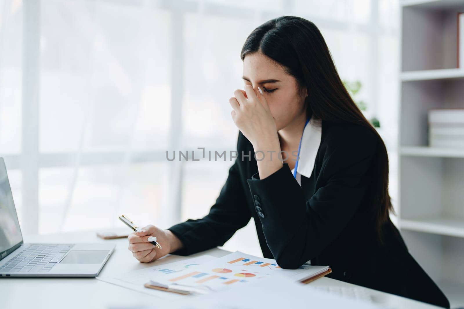 Portrait of business owner, woman using computer and financial statements Anxious expression on expanding the market to increase the ability to invest in business by Manastrong