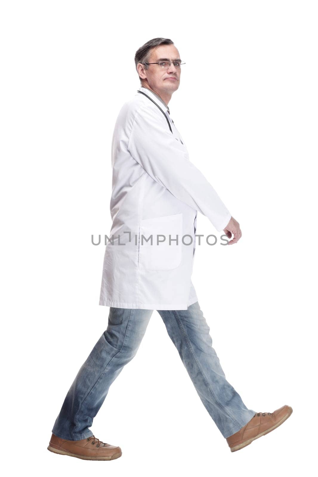 qualified doctor with stethoscope going forward. isolated on a white background.