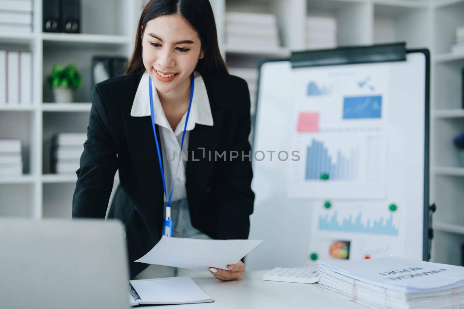 Portrait of young asian woman holding notebook with presentation of strategy, investment plan and marketing