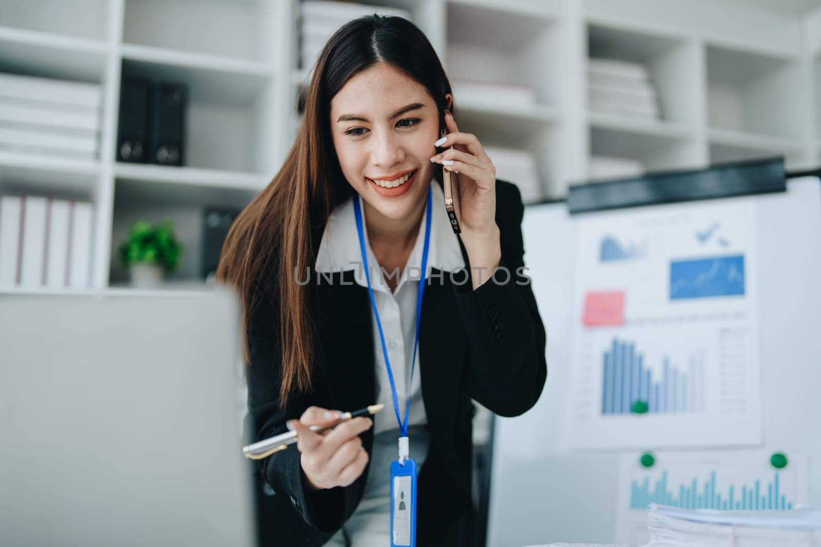 Portrait of young asian woman holding notebook with presentation of strategy, investment plan and marketing