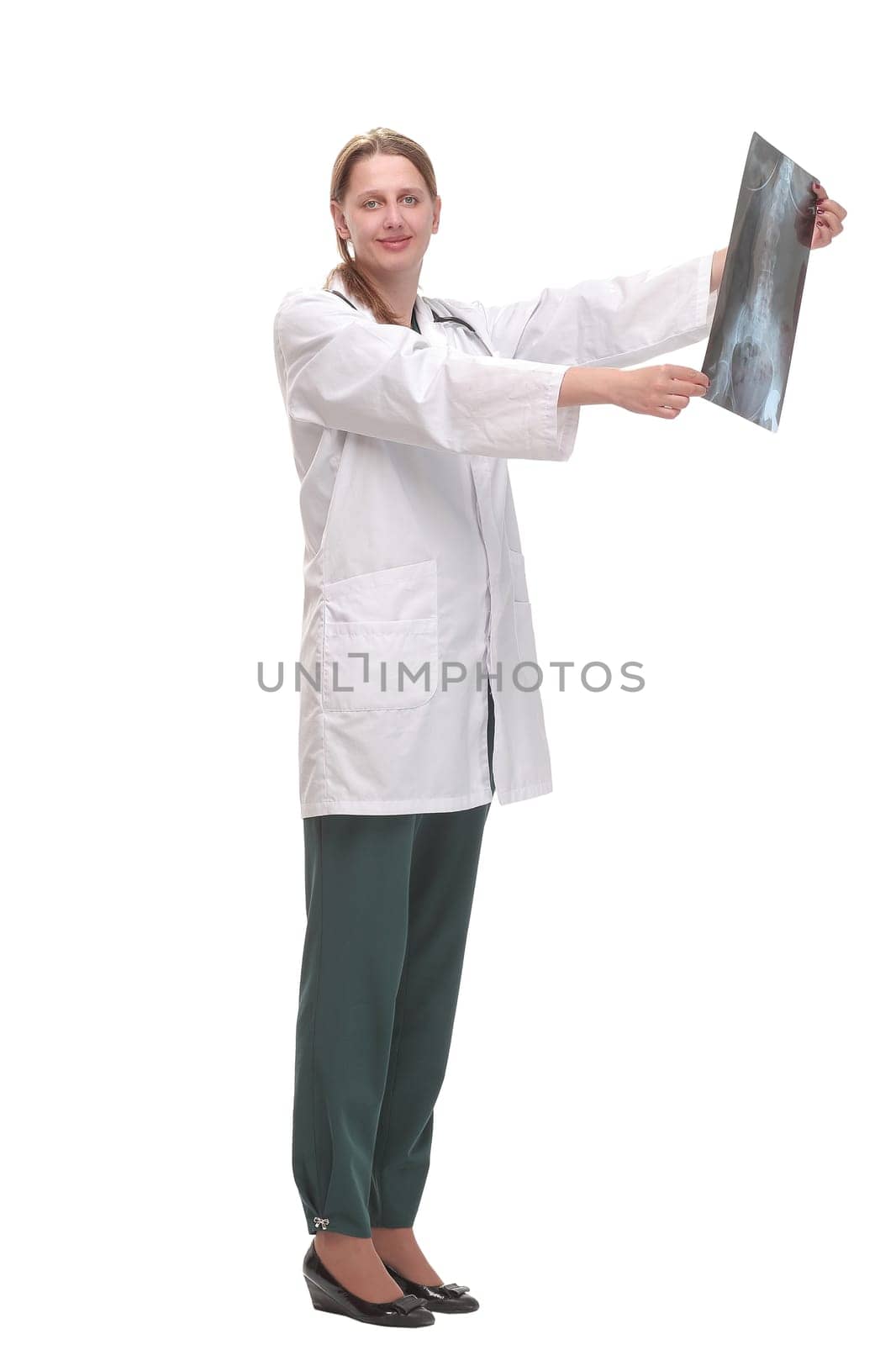 Front view of female doctor wearing stethoscope and glasses looking at an x-ray. Concept of medical help