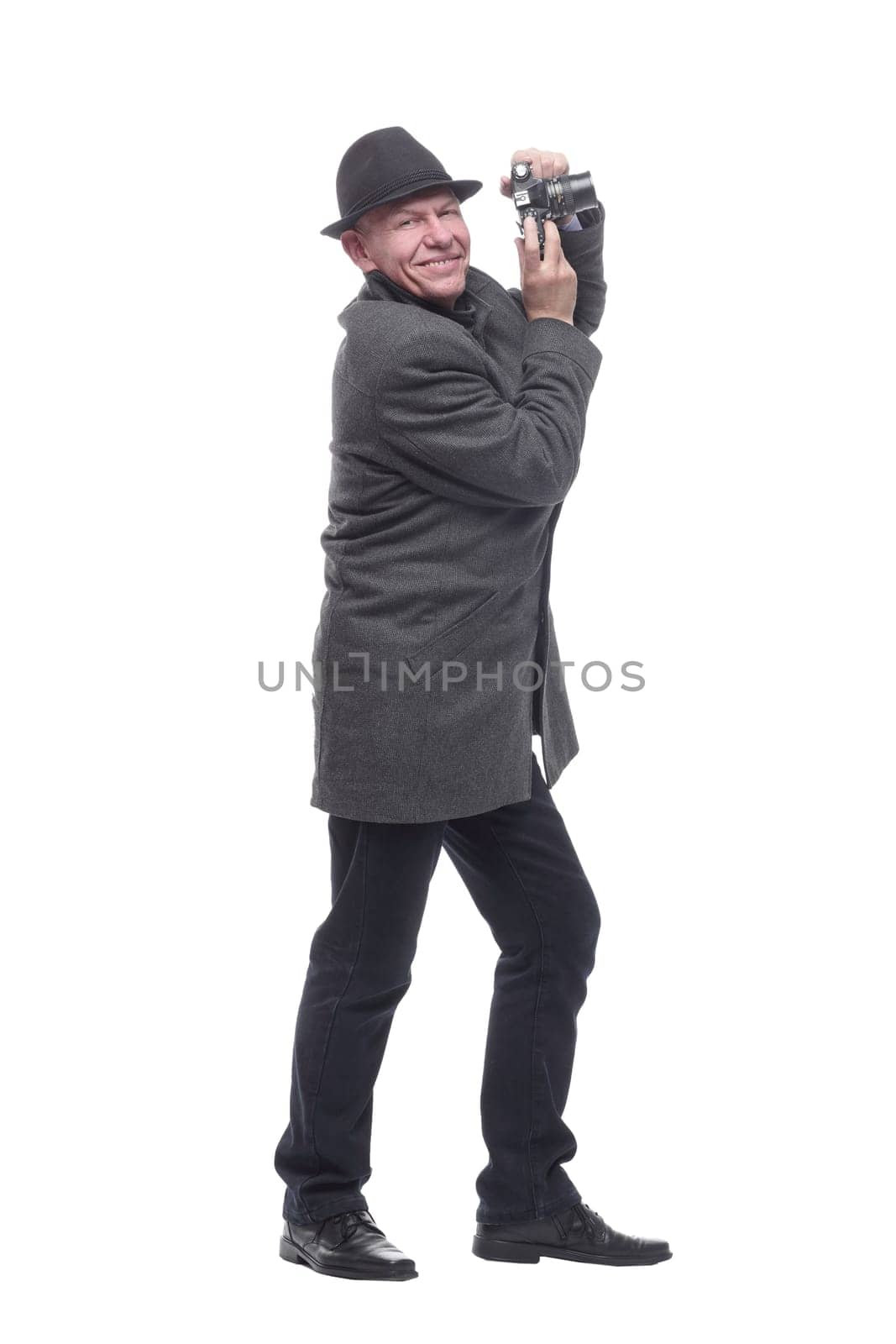 in full growth. Mature intelligent man with a camera. isolated on a white background.