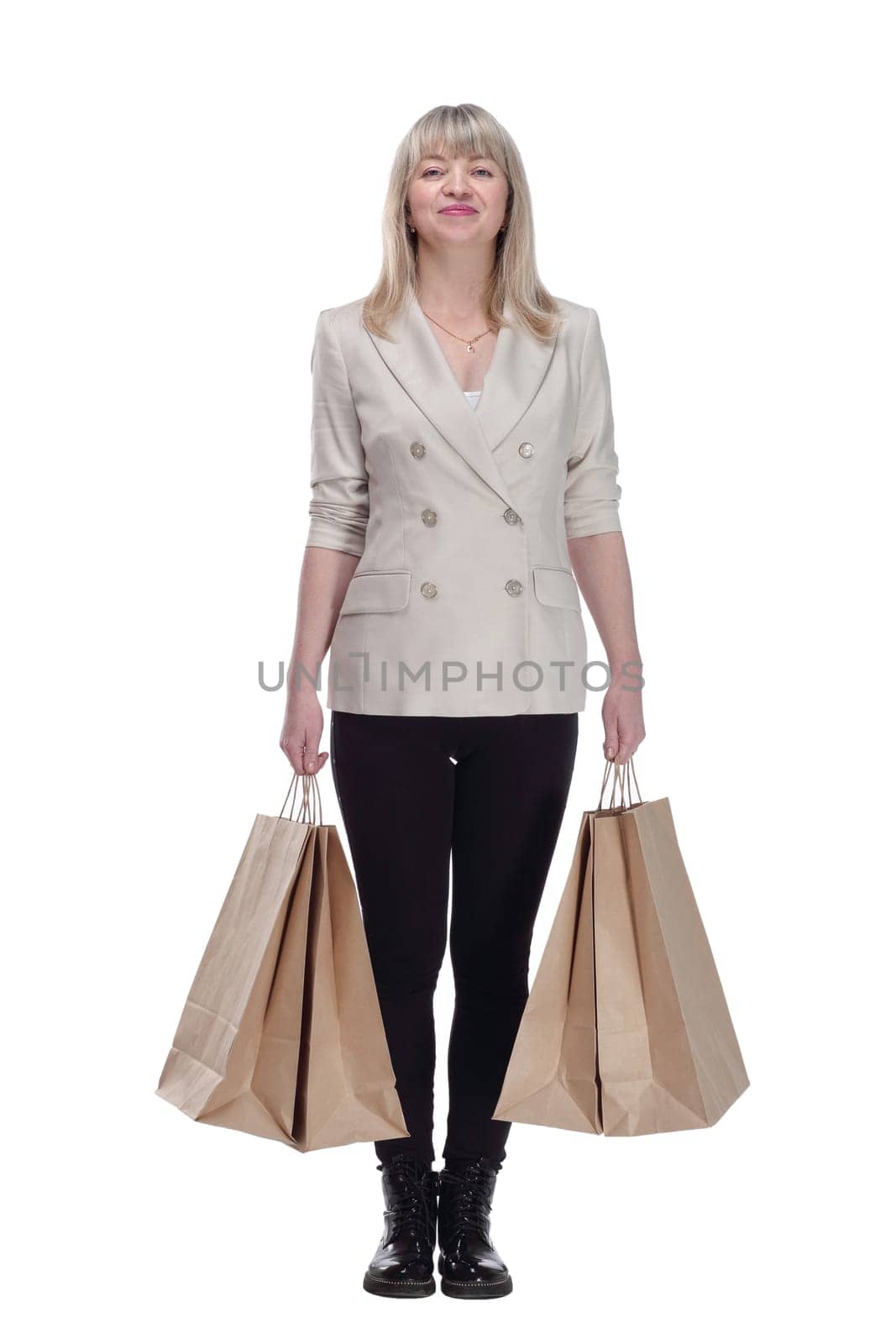 in full growth. smiling blonde woman with shopping bags . isolated on a white background.