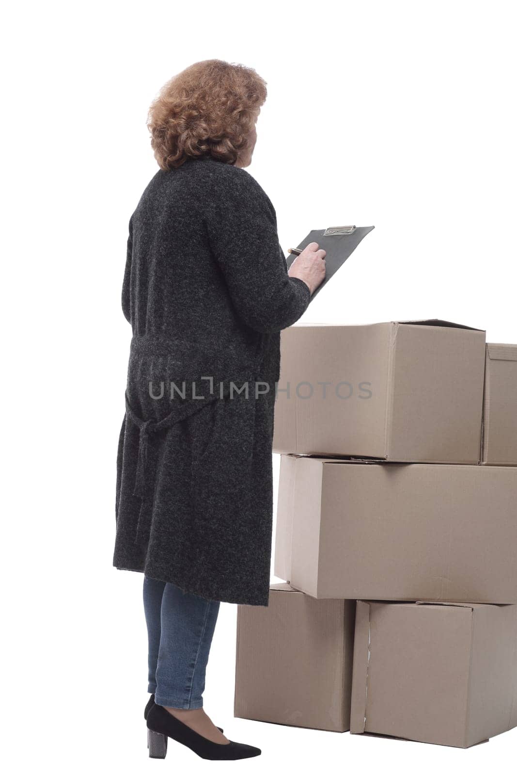 in full growth. serious woman signs documents after delivery. isolated on a white background