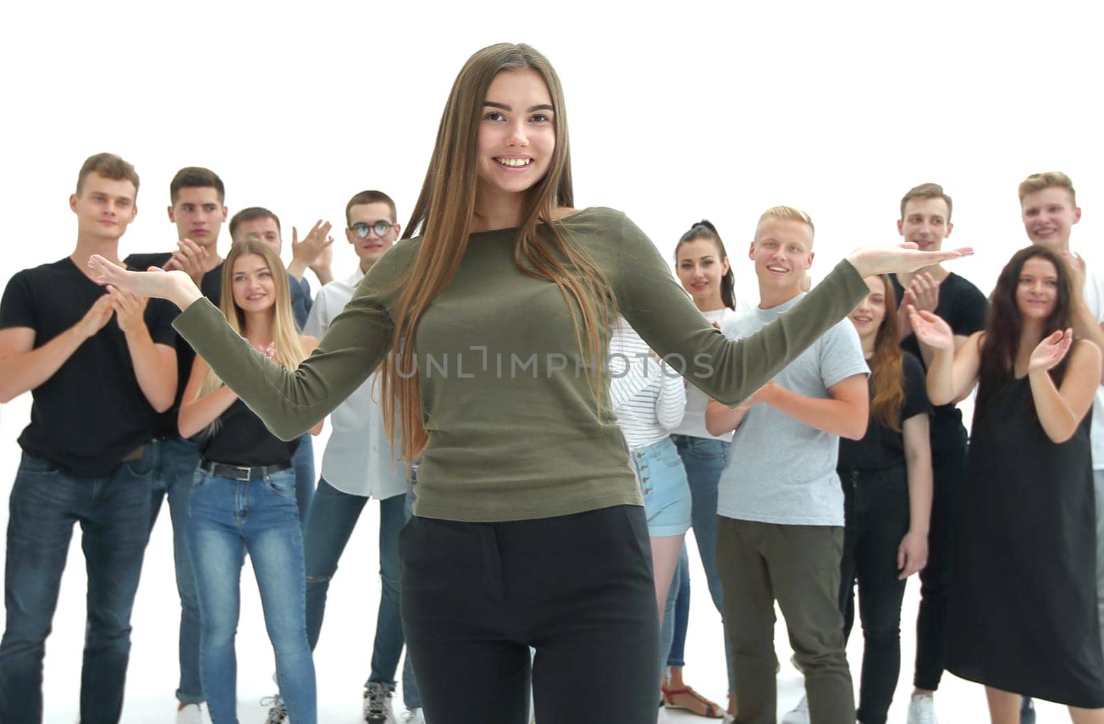 in full growth. happy friendly girl standing in front of a group of her friends. photo with copy space