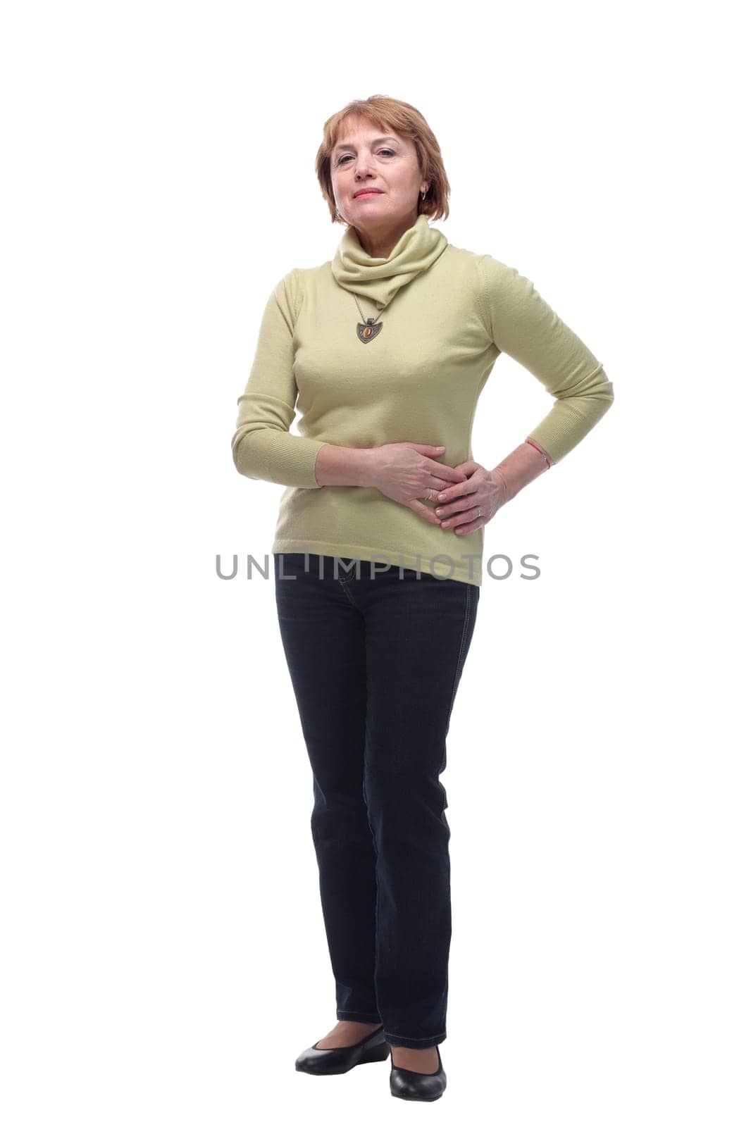 Studio shot of pretty mature woman posing with her hand on hip against white background