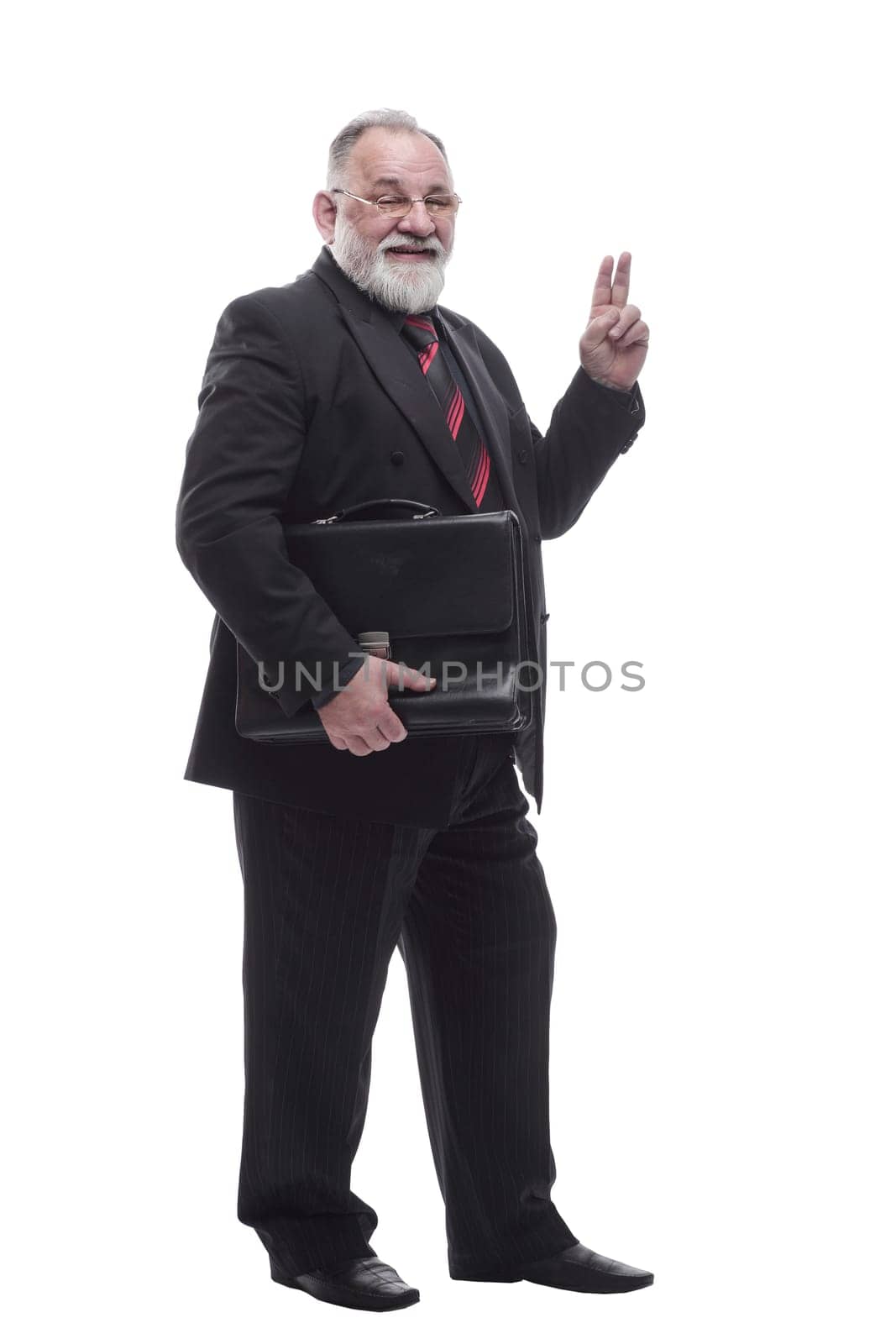 in full growth. smiling business man with a leather briefcase. isolated on a white background