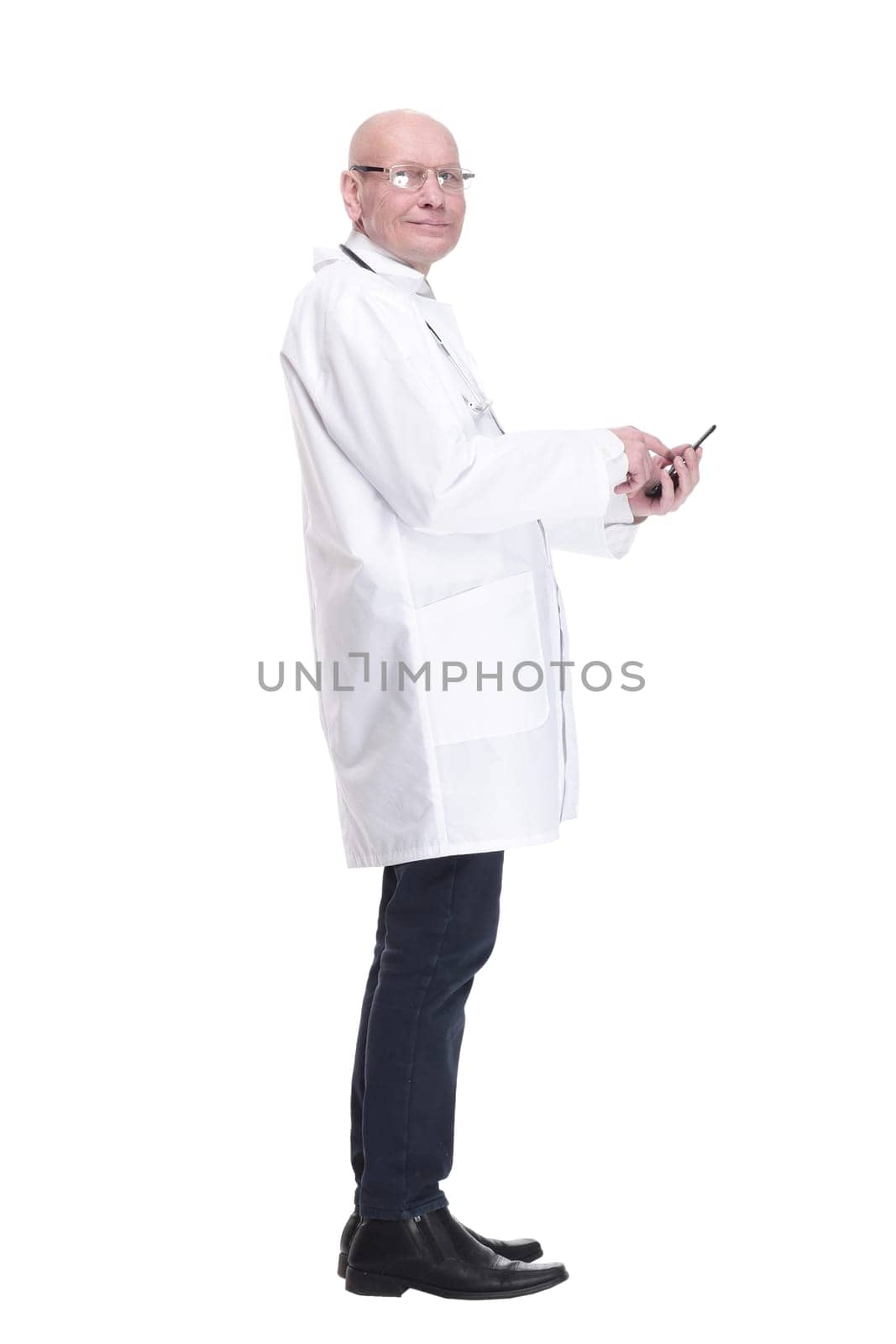 side view . man doctor talking on a mobile phone. isolated on a white background.