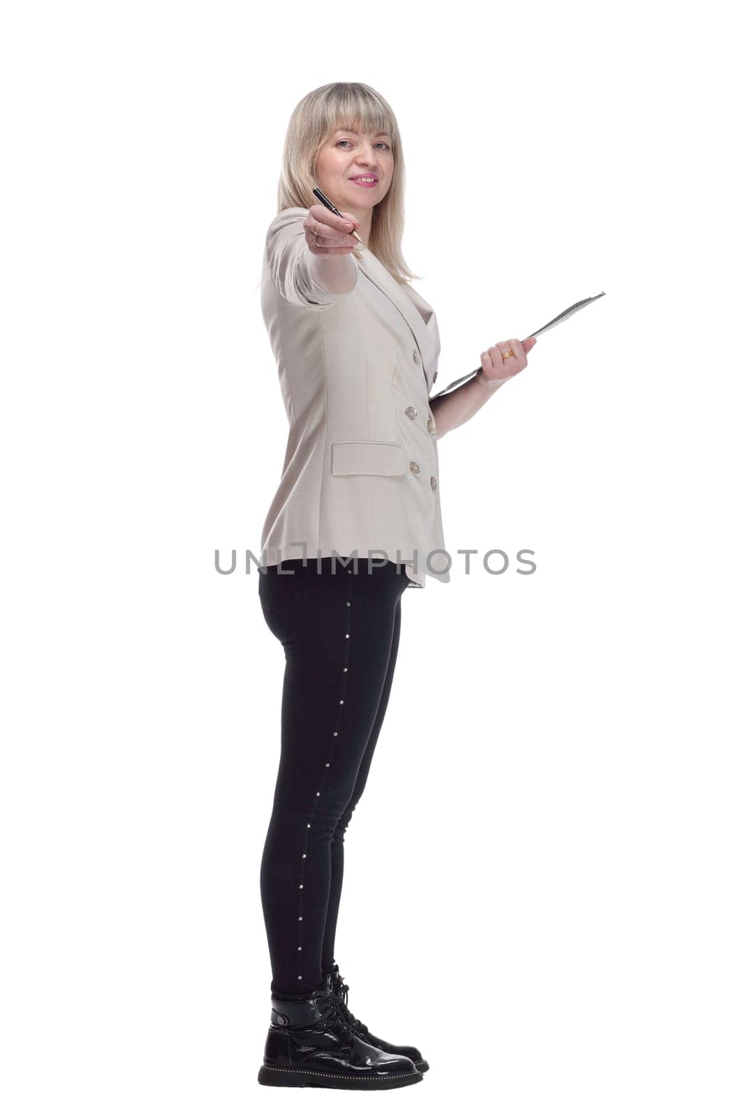 side view. Mature blonde woman writing something to the clipboard . isolated on a white background.