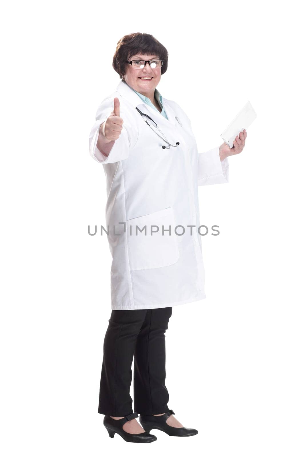 in full growth. senior female doctor with a digital tablet . isolated on a white background.