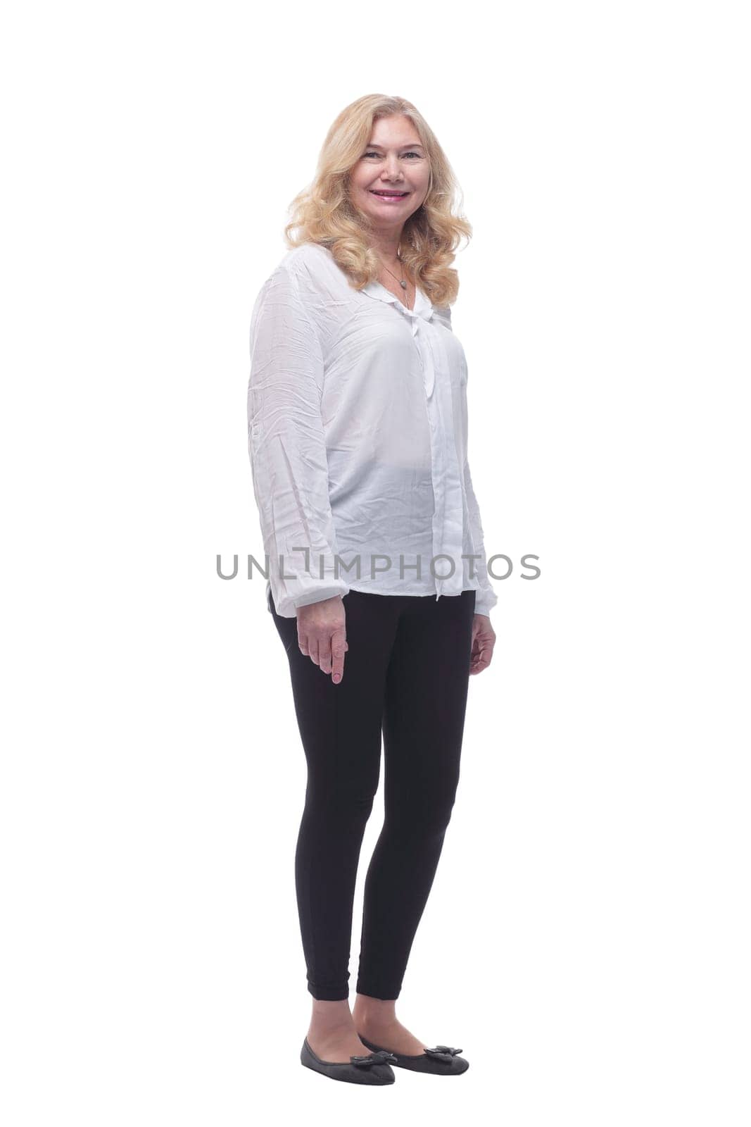 in full growth. happy mature woman in a new blouse striding forward. isolated on a white background.