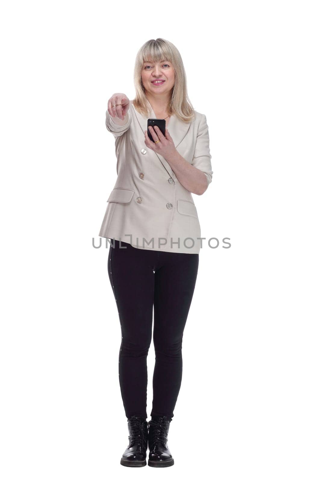 in full growth. attractive woman reading message on her smartphone . isolated on a white background.