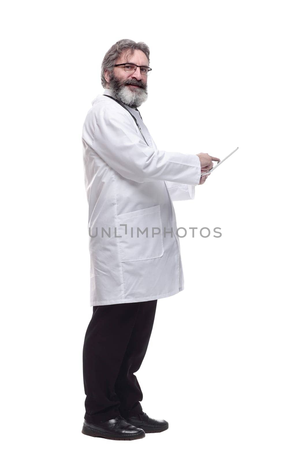 side view. senior doctor using a digital tablet. isolated on a white background