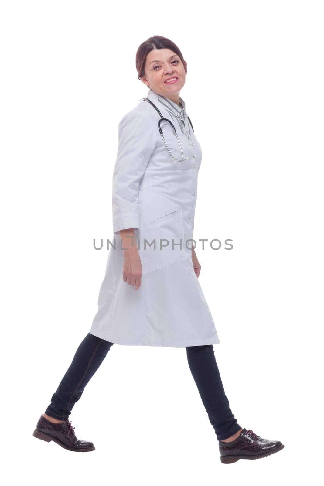 Full length portrait of female doctor walking towards the camera smiling by asdf