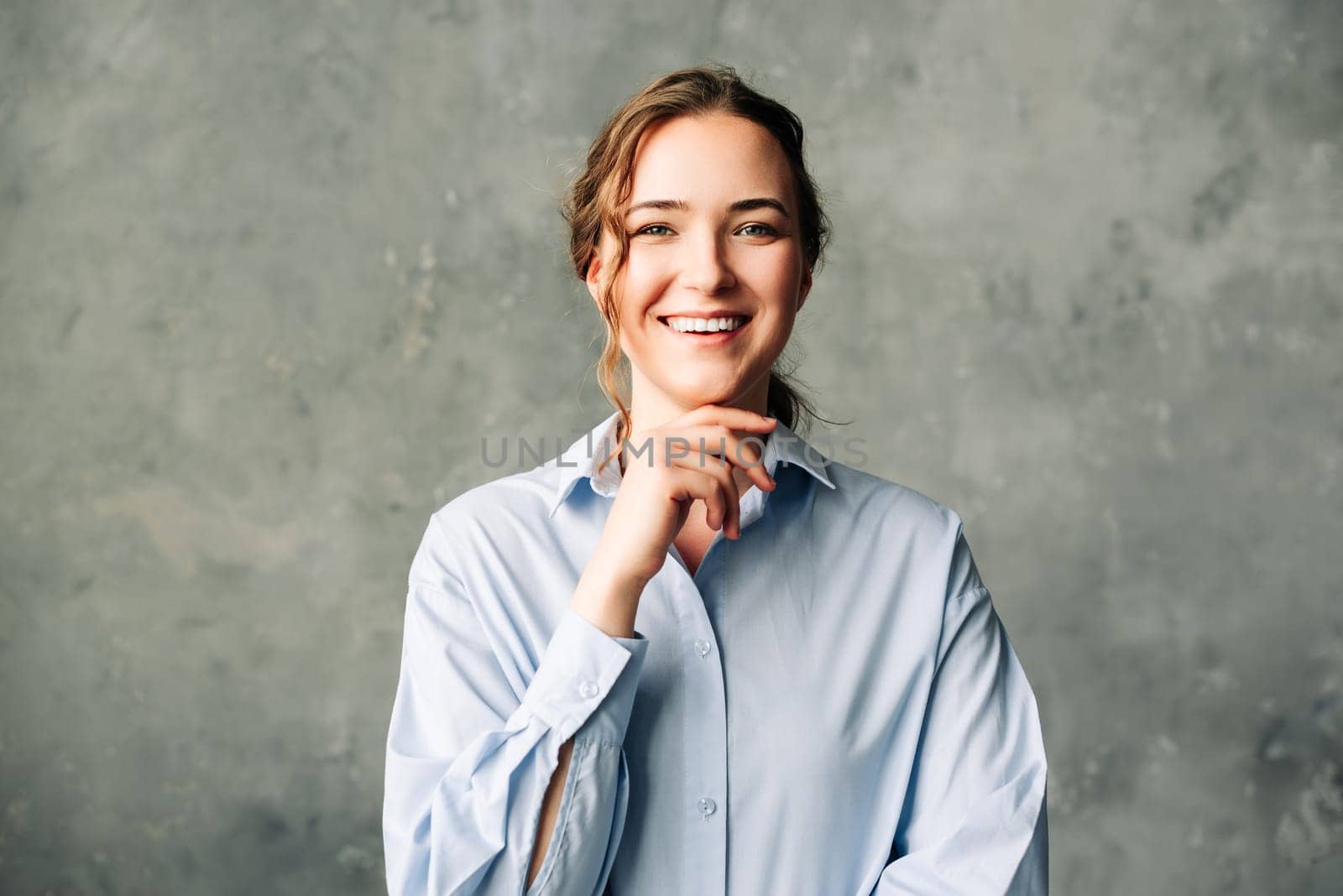 Confident Young Professional Woman Smiling. Vibrant young professional smiling confidently at the camera. Ideal for promoting a positive work environment, business success, and personal branding