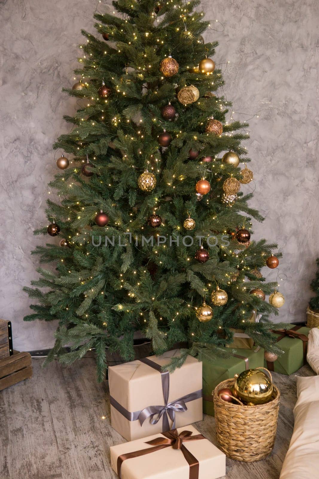 Home New Year's interior. Christmas tree with gifts, decorated with garlands. Cozy atmosphere of a home holiday, loft design of the room, Scandinavian style
