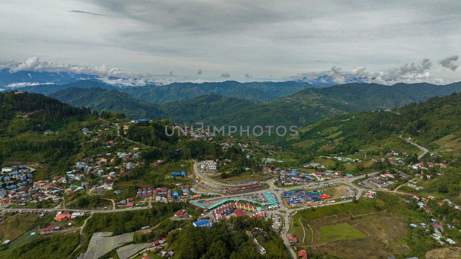 Top view of city is located in the mountains among farmland at the foot of Mount Kinabalu. Kundasang, Ranau. Borneo, Sabah, Malaysia.