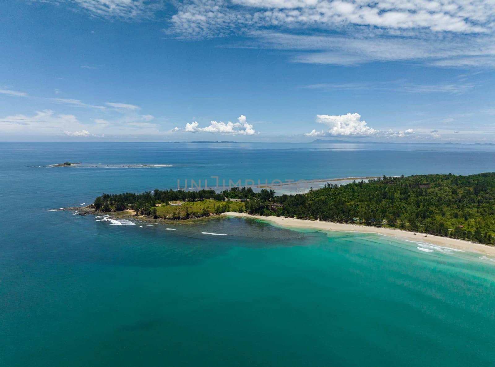 Aerial drone of sandy beach and turquoise water of the tropical sea. Kalampunian beach. Sabah, Borneo, Malaysia.
