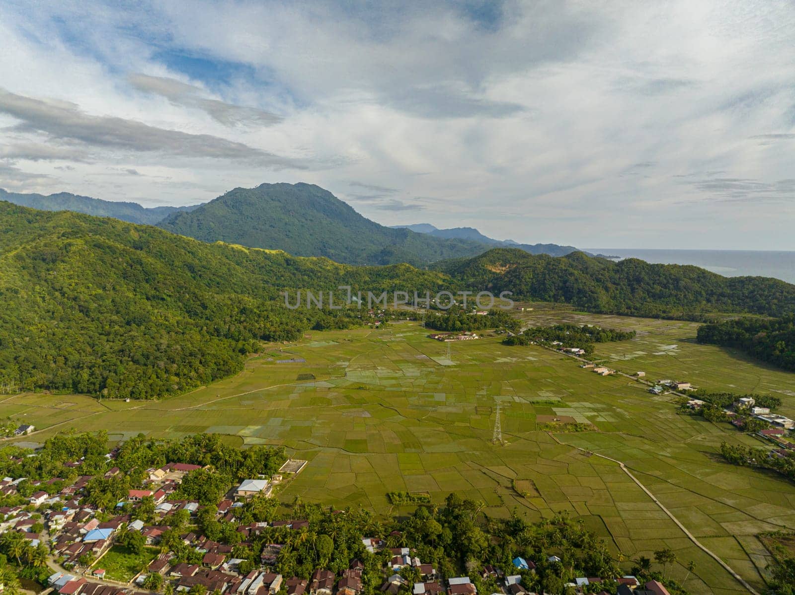 Aerial drone of rice fields and farmland in the mountains of Sumatra. Indonesia.