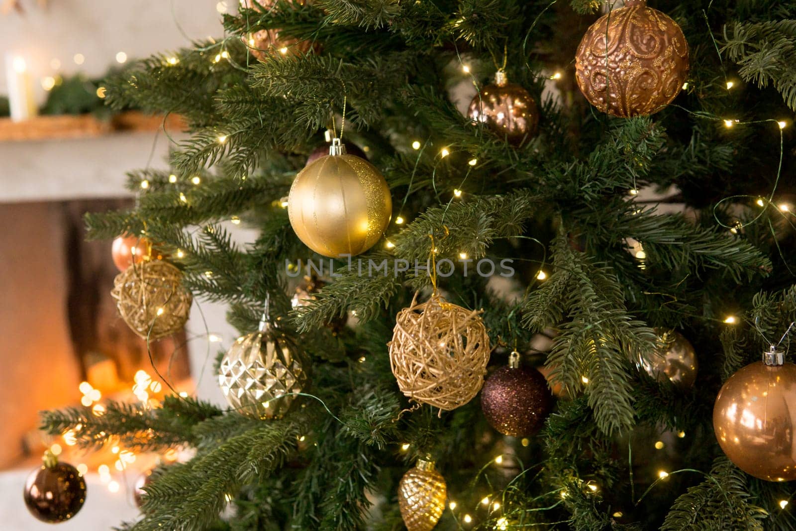 Bronze balls on the Christmas tree close-up. Christmas tree design decorations. The concept of celebrating New Year and Christmas