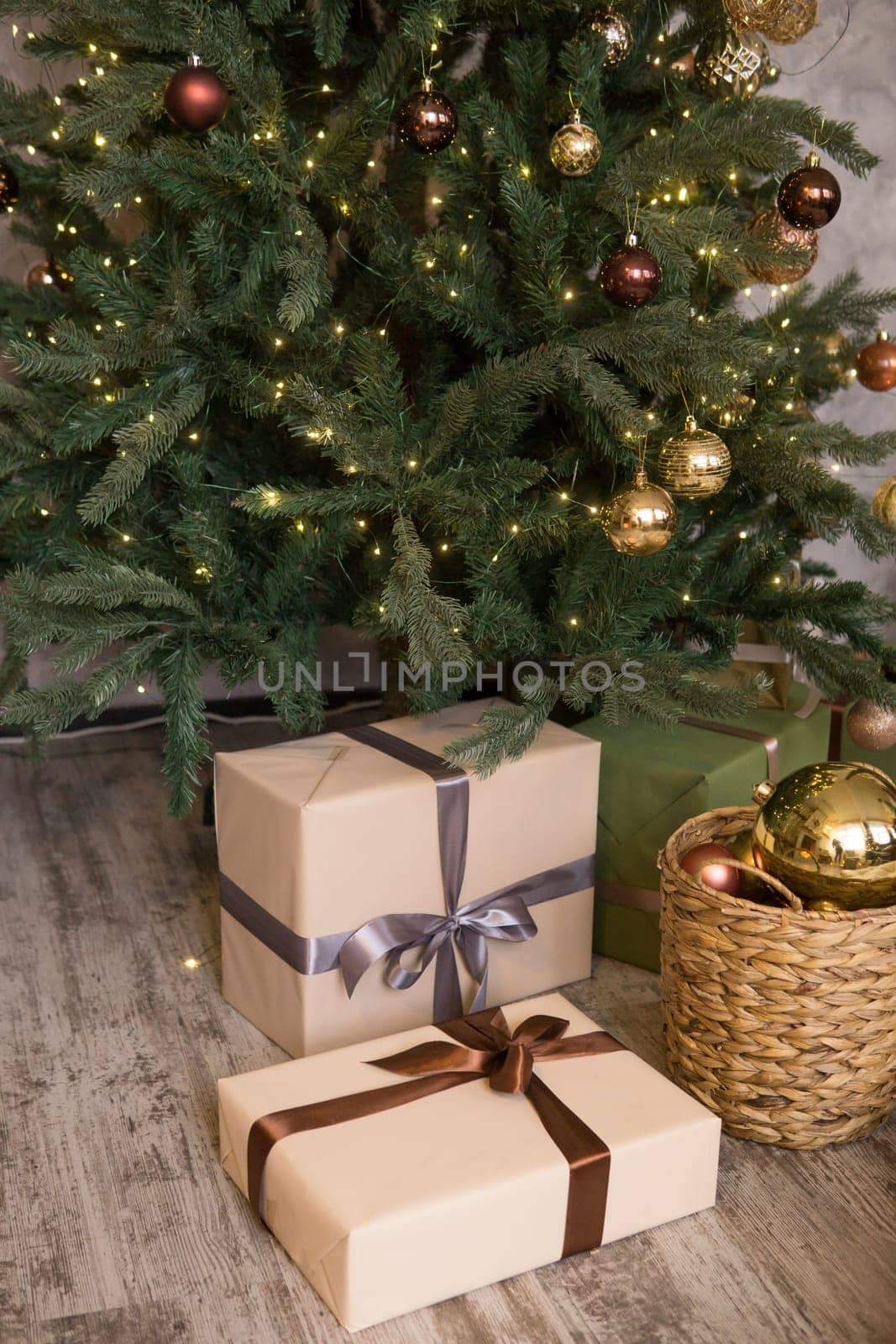Bronze balls on the Christmas tree close-up. Christmas tree design decorations. The concept of celebrating New Year and Christmas