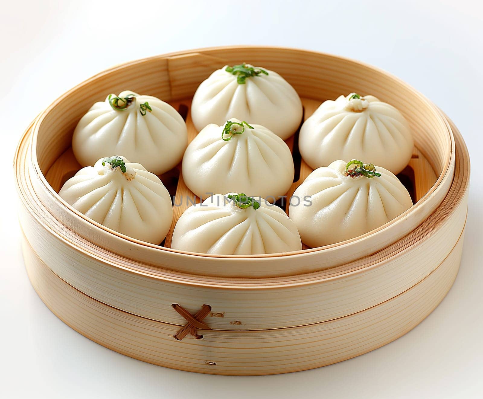 Steamed bao dumplings in bamboo, traditional Asian food, dim sum served in a round wooden container