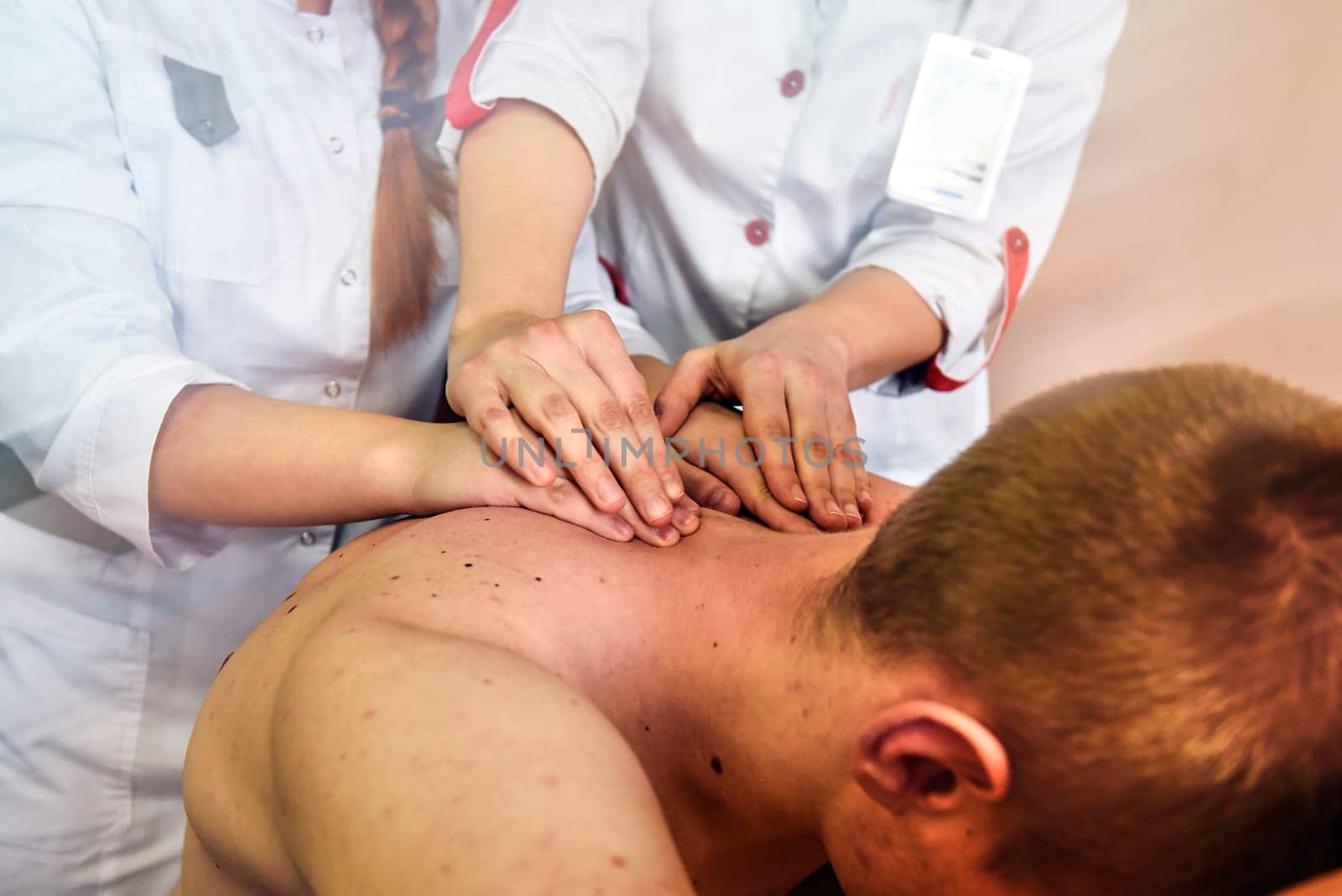 A close-up of a client's back massage. Massage lesson at the medical center.