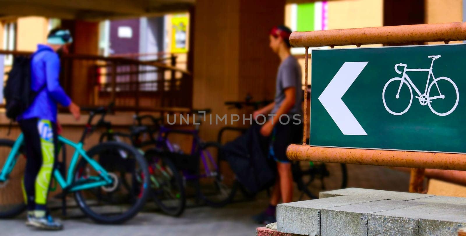 Parking for bicycles in the park. Young people take bicycles. Bicycle sign.