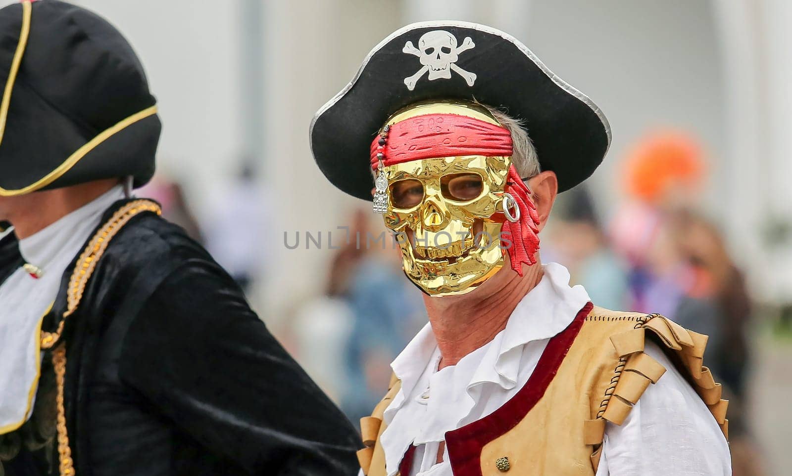A man in an old pirate costume for a carnival at a children's party.