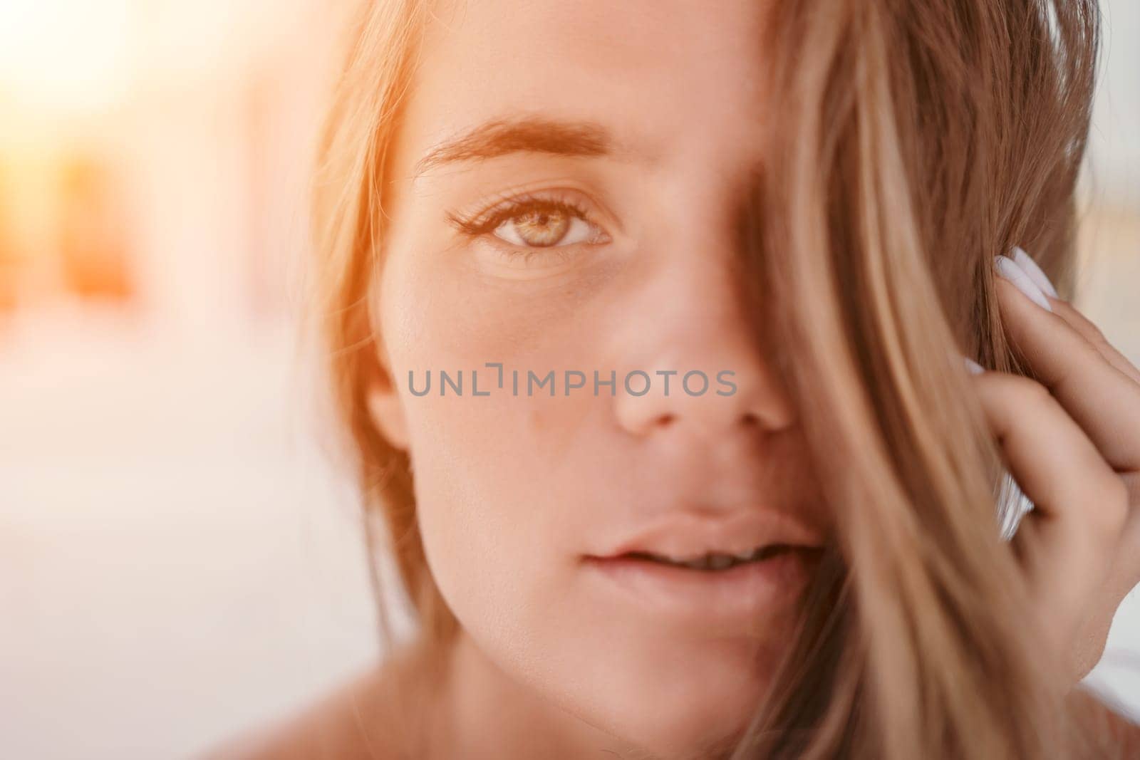 Happy woman portrait in cafe. Boho chic fashion style. Outdoor photo of young happy woman with long hair, sunny weather outdoors sitting in modern cafe