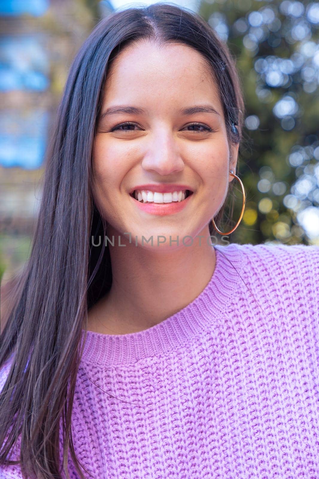 Latin student on campus smiling with headphones looking at camera College life concept.