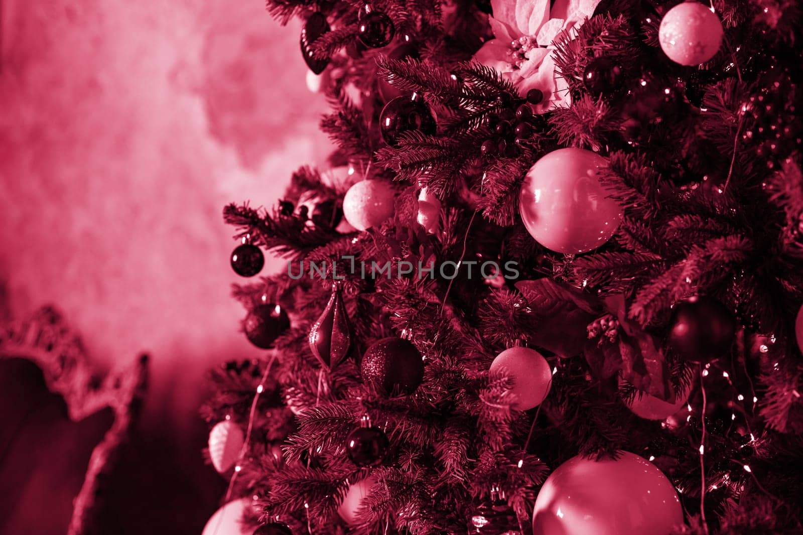 Christmas composition. Lots of silver Christmas tree decorations, top view. Color Viva Magenta. Demonstrating the colors of 2023.