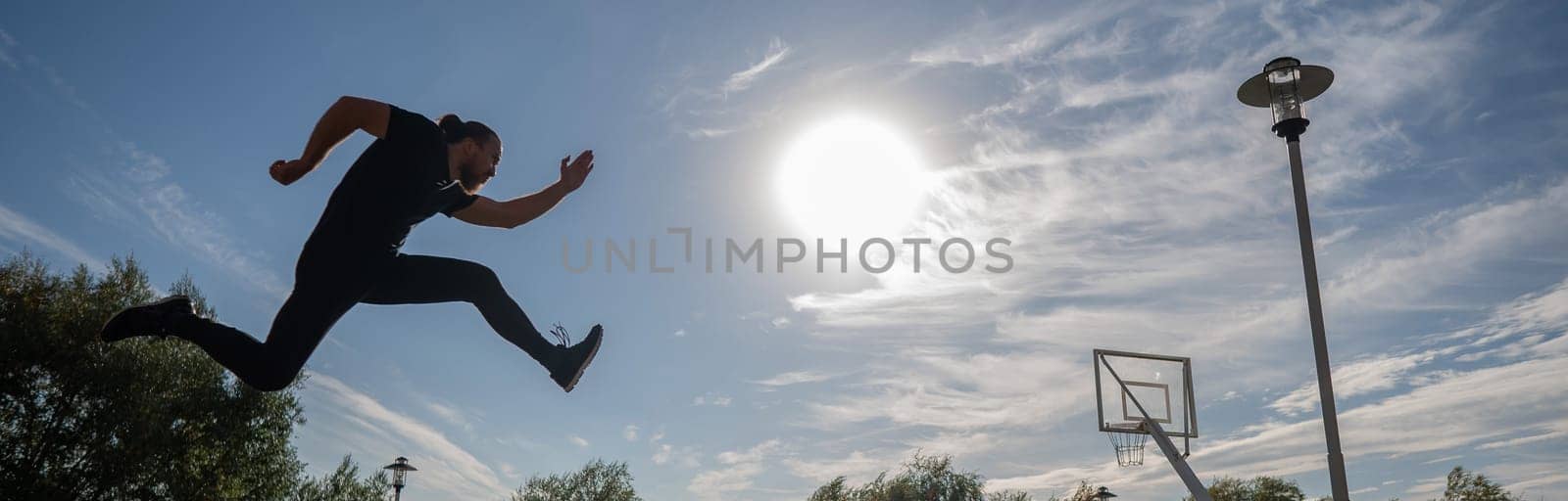 Caucasian man jumping with high hip raise outdoors
