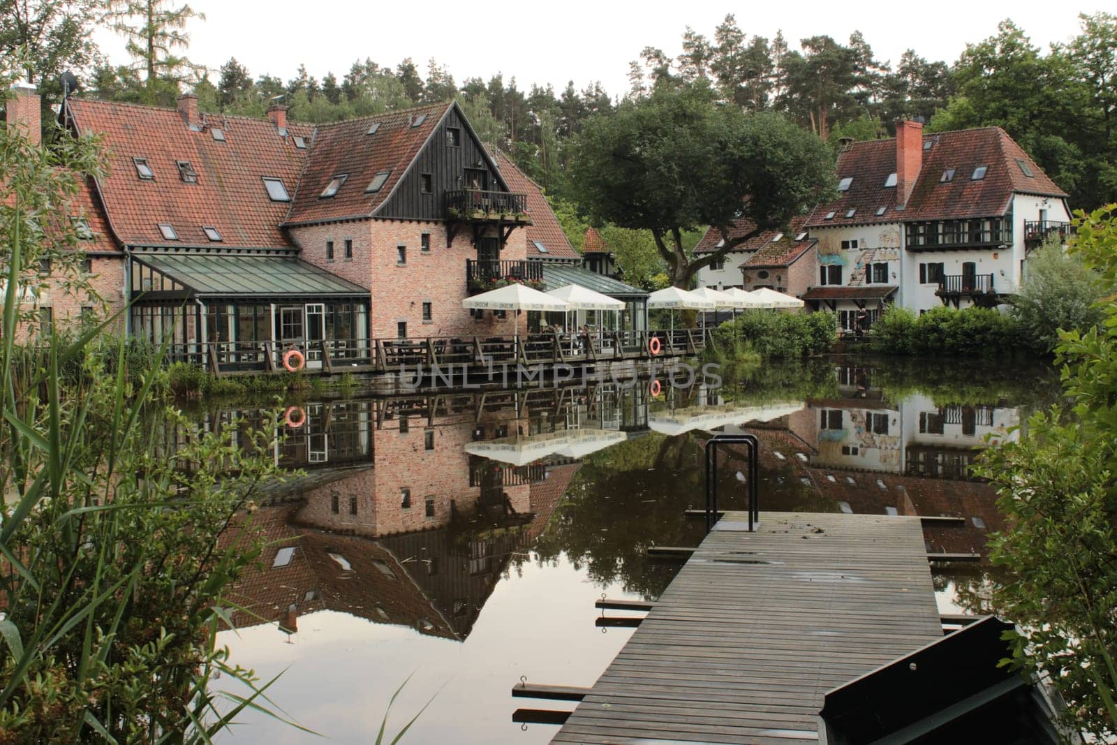 View of a residential building with a cafe-restaurant by the river in the forest. High quality photo
