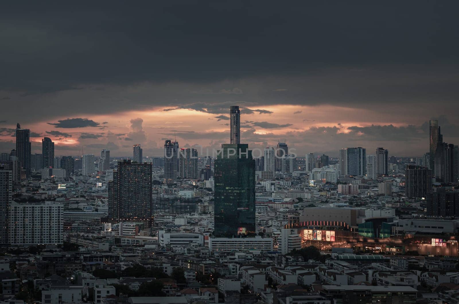 Bangkok, Thailand - 15 Aug 2024 - View of Beautiful Clouds in the Sky over Large Metropolitan City. Bangkok city skyscrapers after sunset with Dramatic sky background before Sunset, Space for text, Selective focus.