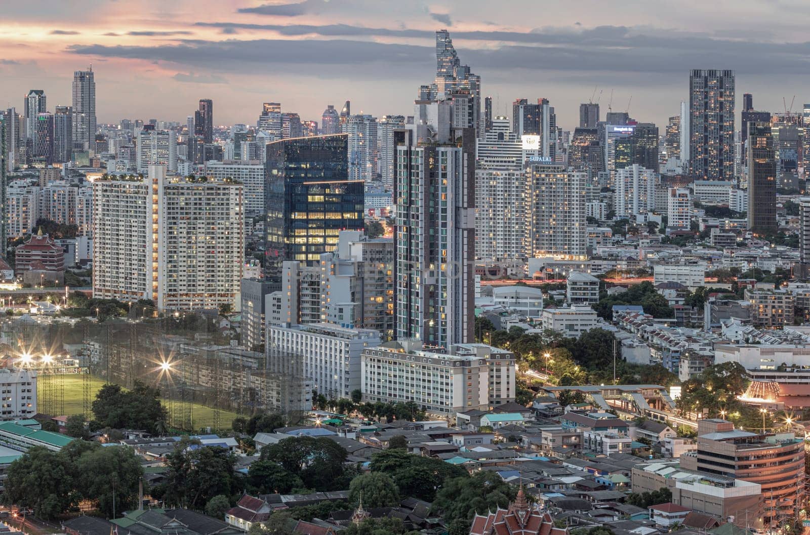 Bangkok, Thailand - 15 Aug 2024 - Bangkok city skyscrapers after sunset with Dramatic sky background before Sunset. View of Beautiful Clouds in the Sky over Large Metropolitan City, Copy space, Selective focus.