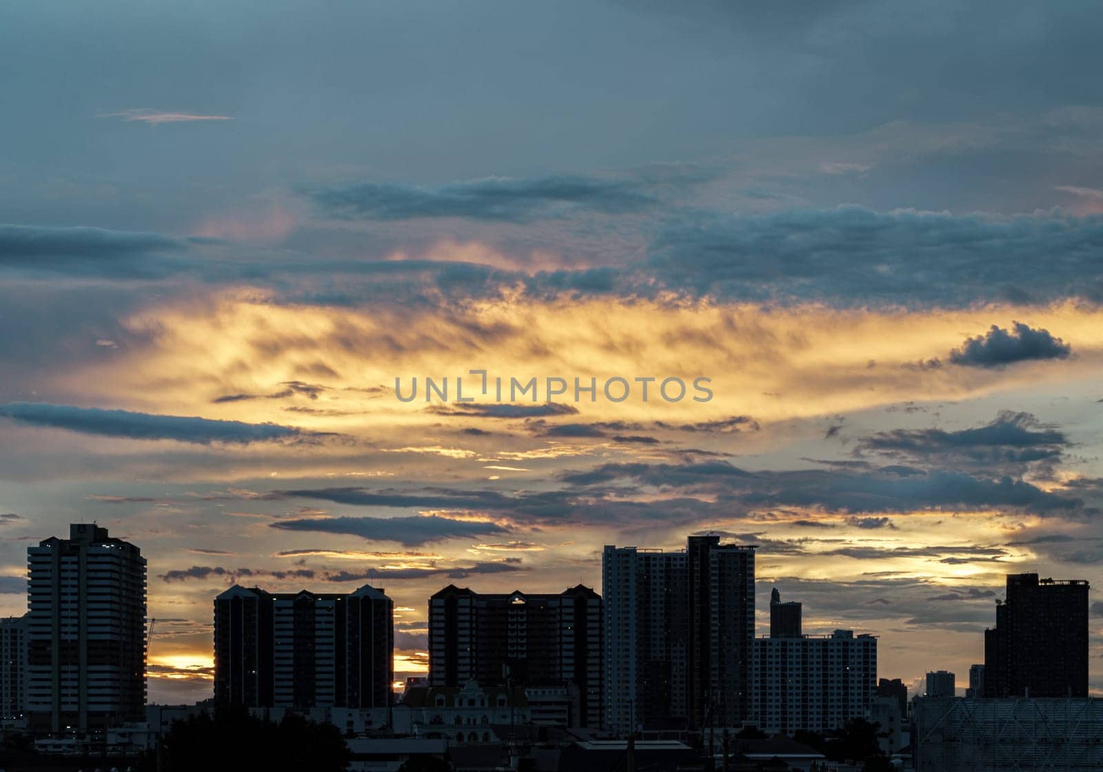 Bangkok, Thailand - 14 Aug, 2024 - Silhouette view of Modern high-rise buildings and background of Dramatic sky in the city of Bangkok. Picturesque view of skyscrapers before Sunset. use it as your Wallpaper, Poster and Space for text, Selective focus.