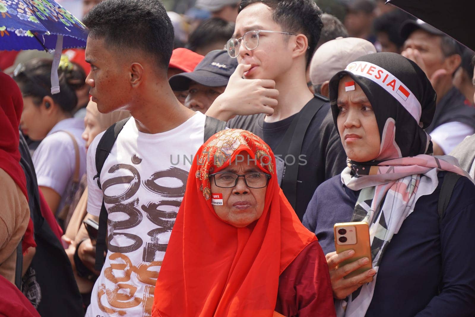 17 August 2024, Jakarta, Indonesia. The atmosphere near the Jakarta Palace during Indonesia's Independence Day is electric, filled with patriotic fervor and national pride. Crowds of people, dressed in red and white, gather to witness the flag-raising ceremony and participate in various festivities.
