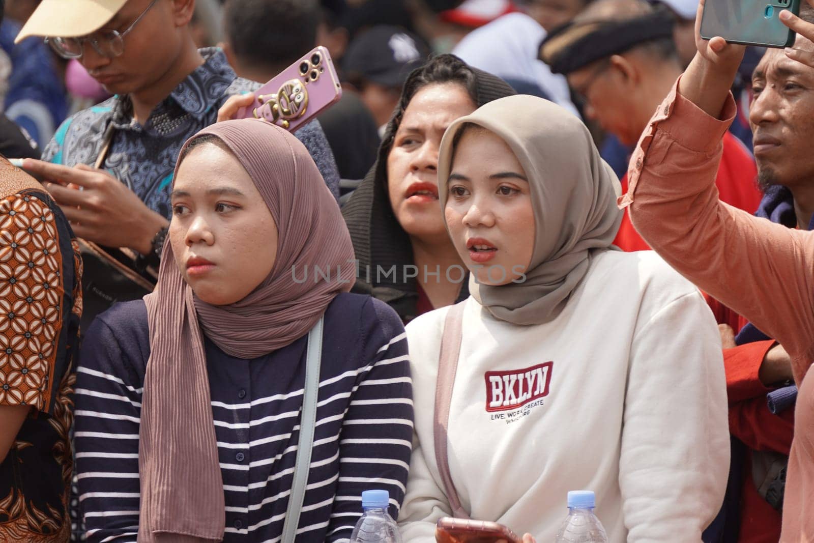 17 August 2024, Jakarta, Indonesia. The atmosphere near the Jakarta Palace during Indonesia's Independence Day is electric, filled with patriotic fervor and national pride. Crowds of people, dressed in red and white, gather to witness the flag-raising ceremony and participate in various festivities.