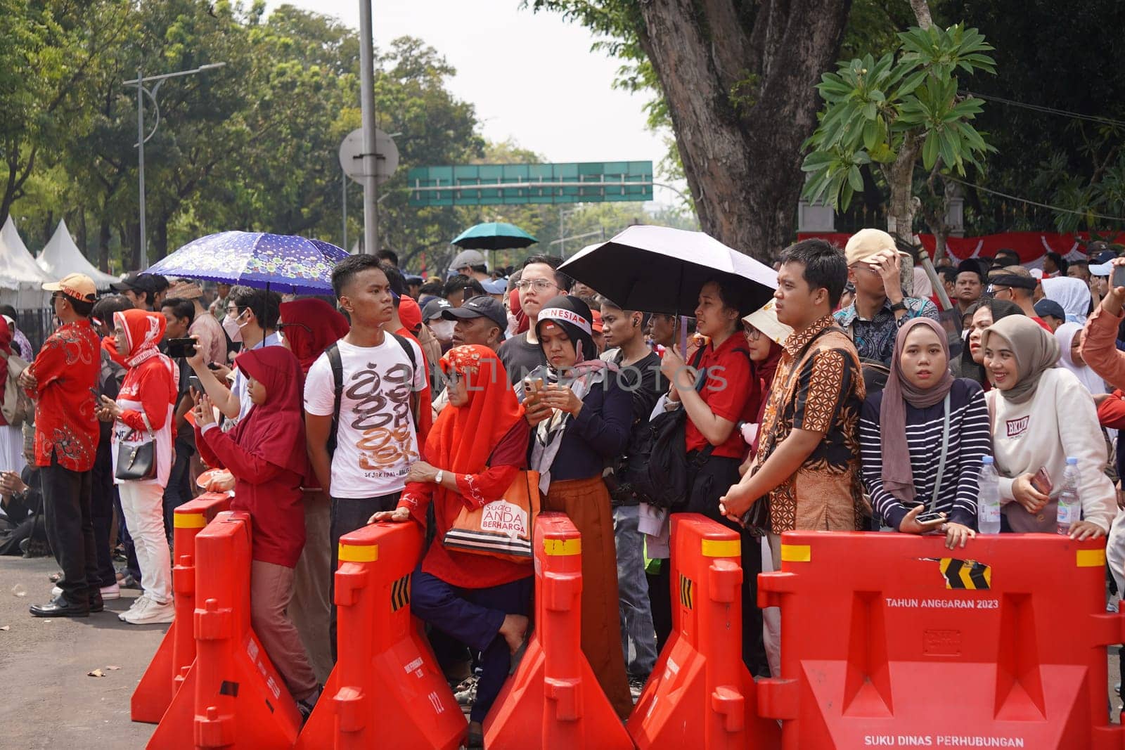 17 August 2024, Jakarta, Indonesia. The atmosphere near the Jakarta Palace during Indonesia's Independence Day is electric, filled with patriotic fervor and national pride. Crowds of people, dressed in red and white, gather to witness the flag-raising ceremony and participate in various festivities.